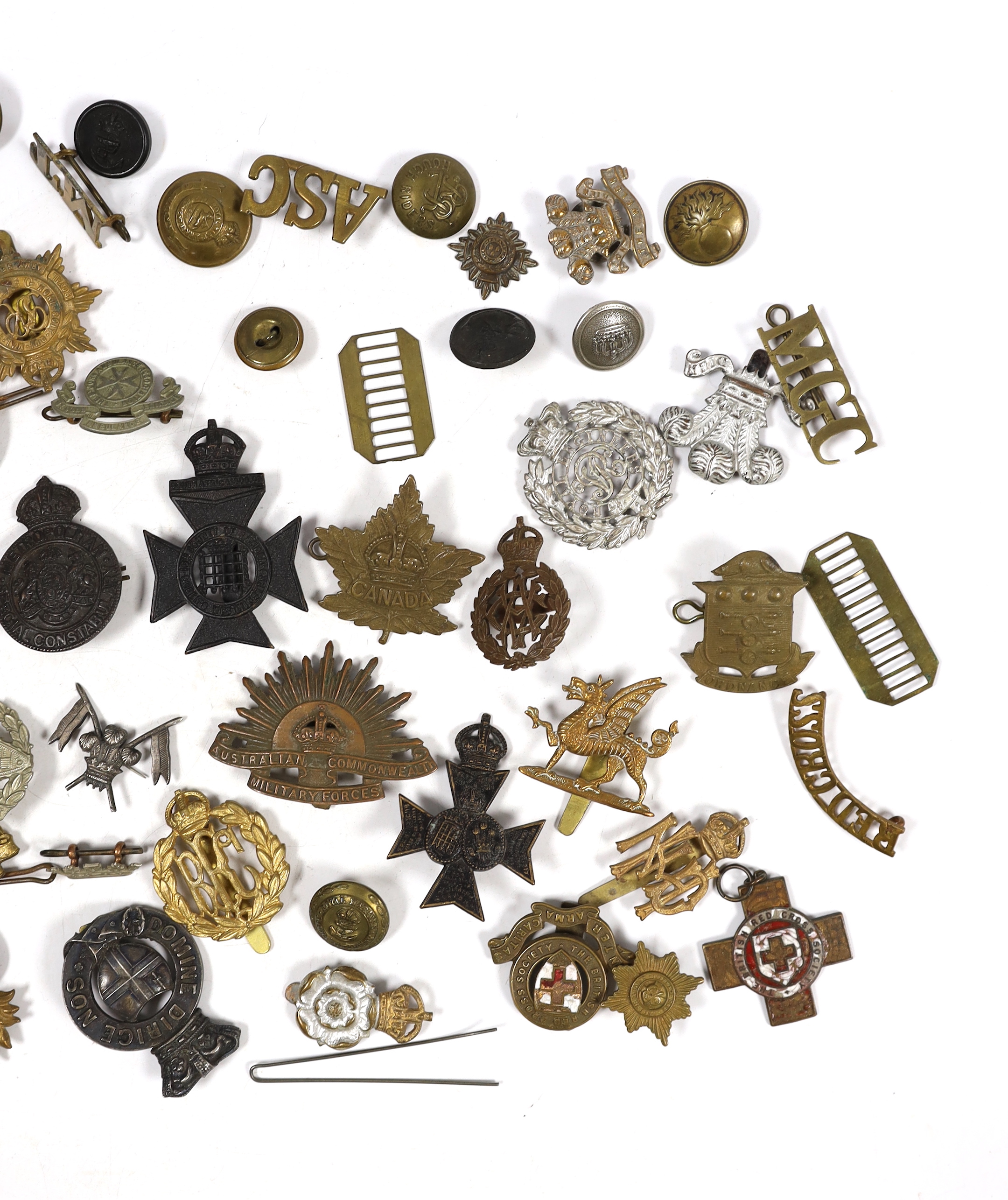 Twenty-five military cap badges including Air Training Corps, Australian Commonwealth Military Forces, Royal Army Ordinance Corps, Royal Engineers, Intelligence Corps, Royal Army Service Corps, RFC, etc. Together with a